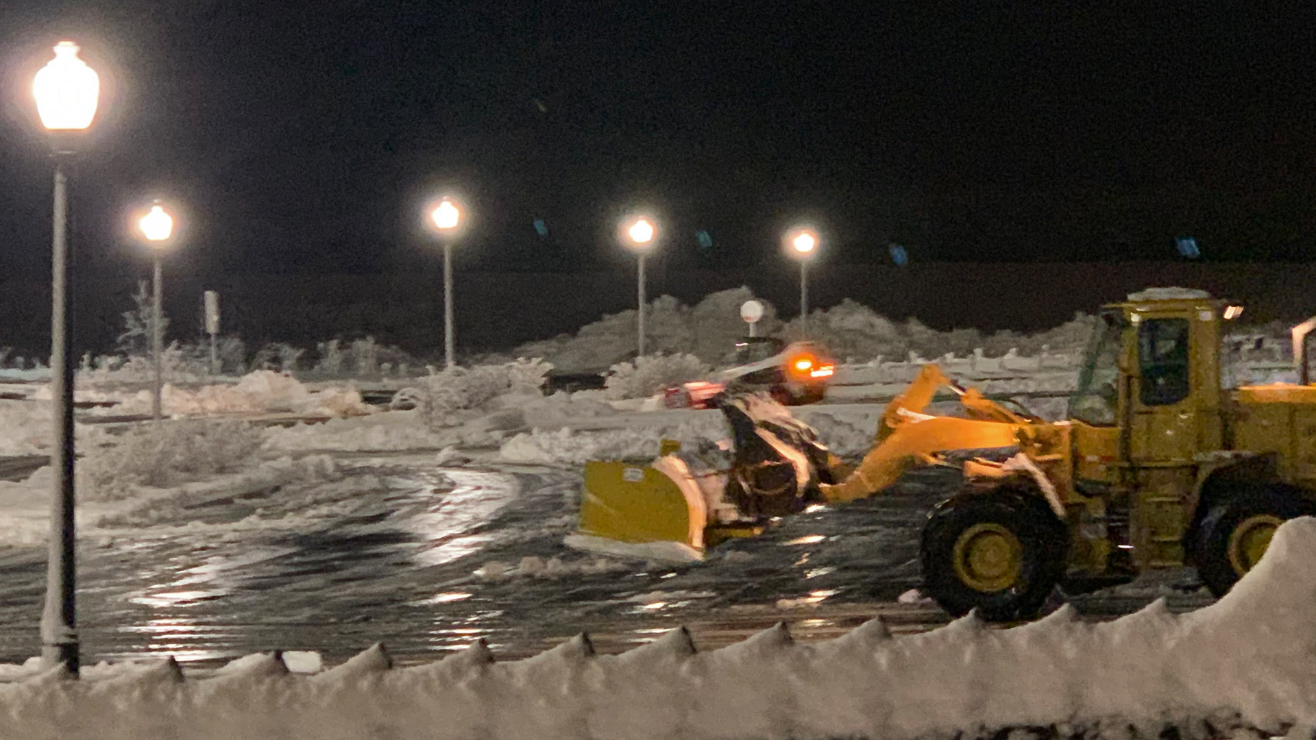 One of our snow plows in a a parking lot that was recently cleared and de-iced.